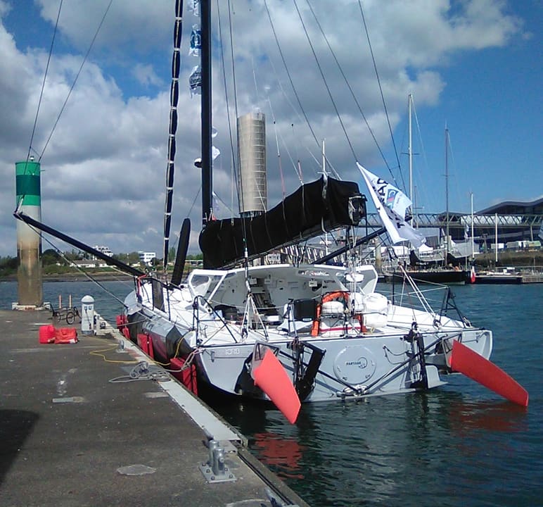 A foiling IMOCA in Lorient before The Transat CIC 2024